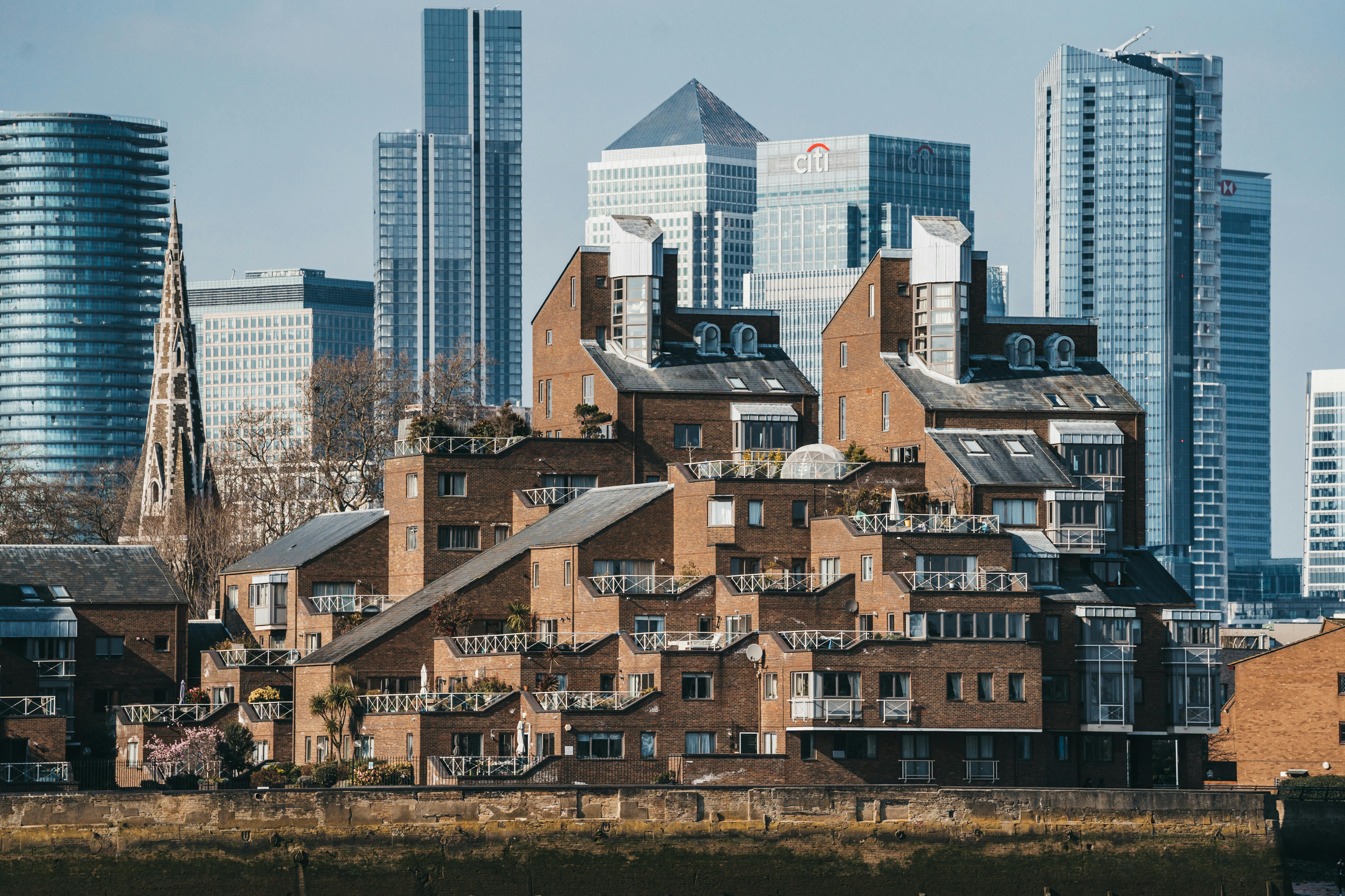 brown brick apartment block with high-rise office buildings in background